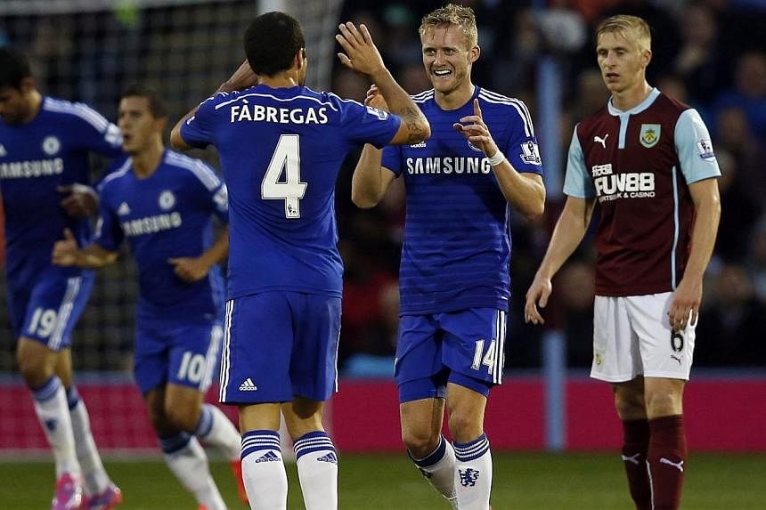 Chelsea's Andre Schurrle (2nd right) celebrates his goal against Burnley with teammate Cesc Fabregas during their English Premier League soccer match at Turf Moor in Burnley, northern England on Aug 18, 2014. -- PHOTO: REUTERS
