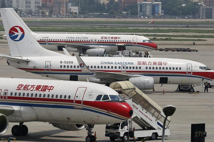 China Eastern Airlines planes are seen on the tarmac at Hongqiao International Airport in Shanghai, on July 29, 2014. -- PHOTO: REUTERS