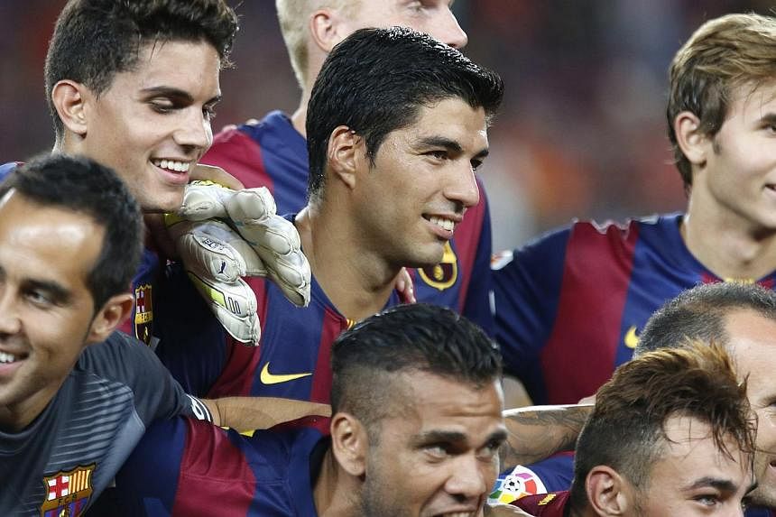 Barcelona's Luis Suarez (centre) celebrates with teammates after winning the Joan Gamper Trophy soccer match against Mexico's Club Leon at Nou Camp stadium in Barcelona on Aug 18, 2014. -- PHOTO: REUTERS