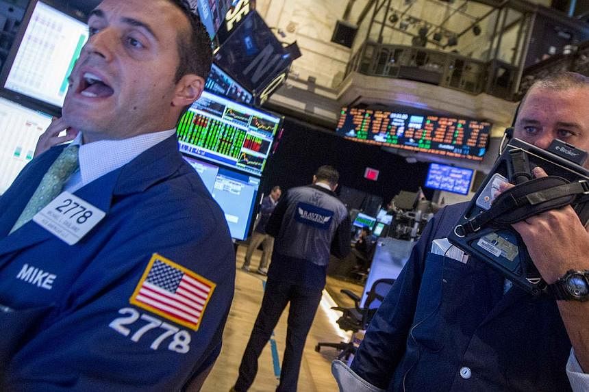 Traders work on the floor of the New York Stock Exchange on August 18, 2014.&nbsp;The Dow Jones Industrial Average finished up 175.83 points (1.06 per cent) at 16,838.74. -- PHOTO:&nbsp;REUTERS