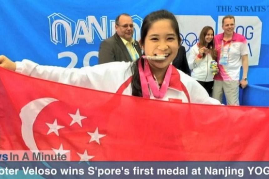 In today's News In A Minute, we look at Martina Lindsay Veloso winning the silver medal in the girls 10-metre air rifle, earning Singapore's first medal at the Nanjing Youth Olympic Games.&nbsp;-- SCREENGRAB FROM RAZORTV VIDEO