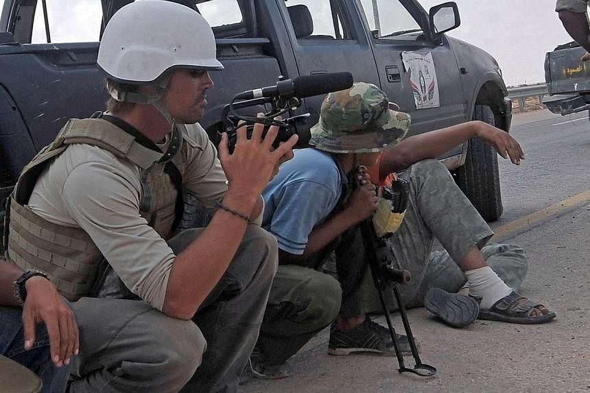 File picture taken on September 29, 2011 shows US freelance reporter James Foley (left) on the highway between the airport and the West Gate of Sirte, Libya.&nbsp;Iraqi Foreign Minister Hoshiyar Zebari urged the world on Wednesday to back his country