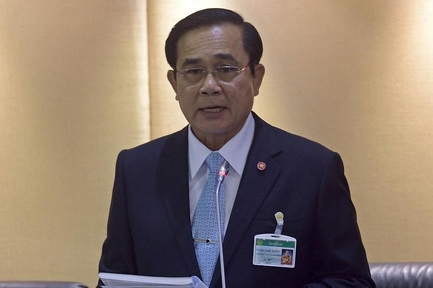 Thailand's army chief and head of the National Council for Peace and Order, General Prayuth Chan-ocha, reads statements to members of the National Legislative Assembly (NLA) at Parliament in Bangkok on Aug 18, 2014.&nbsp;-- PHOTO: AFP
