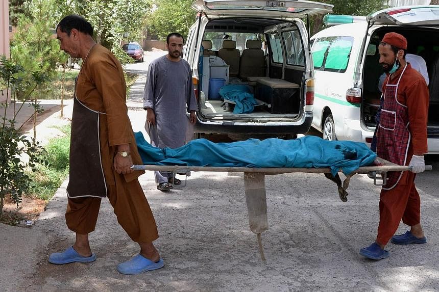 Afghan medical workers carry one of the bodies of two foreign female aid workers&nbsp;gunned down by men on a motorcycle in July 2014. Research released on Tuesday for 2013 shows&nbsp;Afghanistan topped the list of countries where aid workers faced g