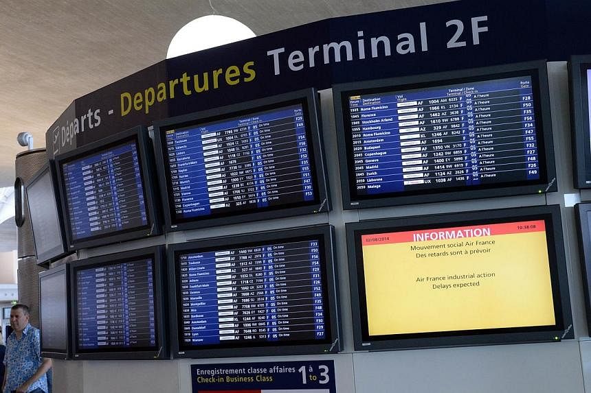 A photo taken on Aug 2, 2014 shows information and departure boards at the Roissy-Charles-de-Gaulle airport, in Roissy-en-France.&nbsp;Some Air France flight crews are refusing to board planes bound for Guinea, Sierra Leone and Nigeria over fears of 