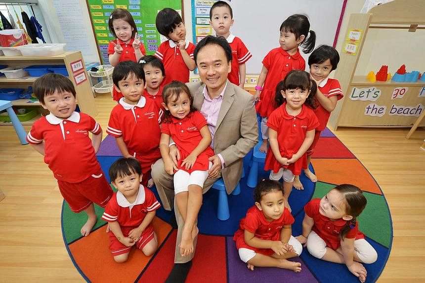 Mr David Chiem, founder and chief executive officer of MindChamps Preschool, with children at the pre-school's branch in Paragon on Nov 28, 2013. Singapore Press Holdings has bought a stake in the pre-school and enrichment provider. -- PHOTO: ST FILE