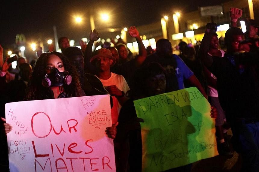 Demonstrators protest the shooting death of Michael Brown, in Ferguson, Missouri on Aug 19, 2014.&nbsp;Protesters hit the streets of the US town roiled by days of unrest over the killing of an unarmed black teen, hours after police shot dead a knife-