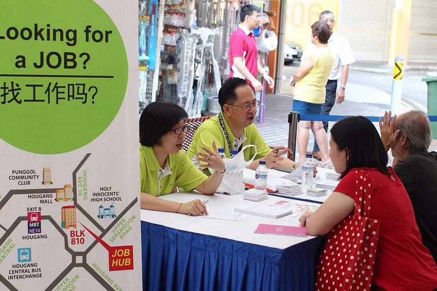 Two residents talking to recruiters at the job fair organised by the North East Community Development Council at Hougang Central Court on 16 April 2014.&nbsp;Small businesses in Tampines, who have been finding it hard to hire workers, were given a he