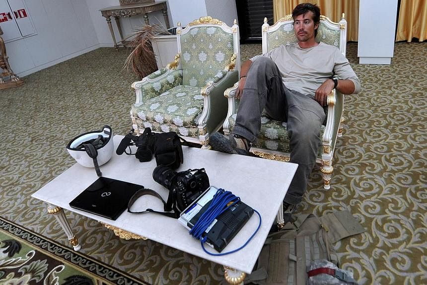 File picture taken on Sept 29, 2011 shows US freelance reporter James Foley resting in a room at the airport of Sirte, Libya. -- PHOTO: AFP