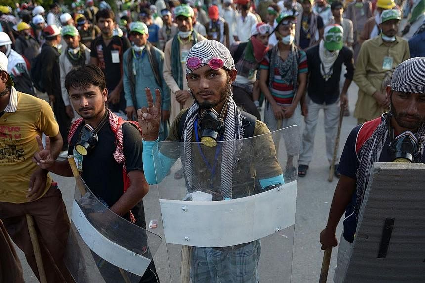 Supporters of Canada-based preacher Tahir-ul-Qadri gather at an anti-government march in Islamabad on August 19, 2014. Qadri and opposition politician Imran Khan&nbsp;led protesters marching on parliament in a high-stakes bid to depose the prime mini