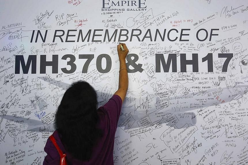 A Malaysian bank officer and her husband were charged Wednesday with forgery, theft and other offences after allegedly stealing RM110,643 (S$43,662.74) from the accounts of four people who were aboard missing flight MH370. -- PHOTO: REUTERS