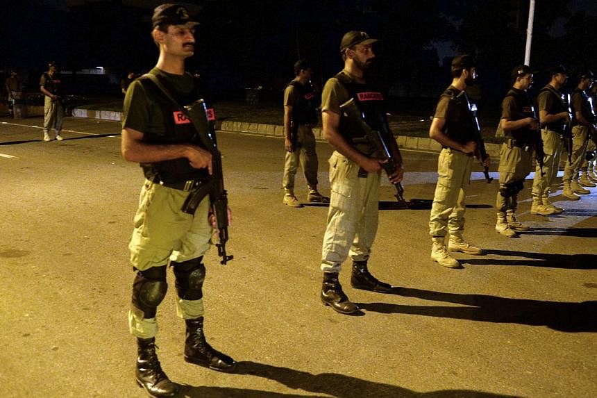 Pakistani paramilitary soldiers cordon off a street leading to a diplomatic enclave during a protest march by opposition groups in Islamabad on Aug 20, 2014. -- PHOTO: AFP