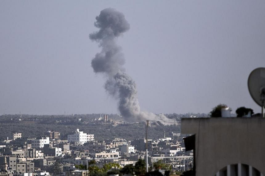 Smoke billows following an Israeli military strike on Gaza City on August 19, 2014. Israel ordered its negotiators back from talks in Cairo and warplanes hit Gaza after Palestinian rockets smashed into the south as the two sides were observing a 24-h
