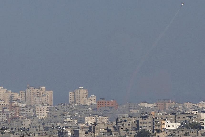 A smoke trail is seen as a rocket is launched from the Gaza Strip towards Israel on Aug 20, 2014. -- PHOTO: REUTERS