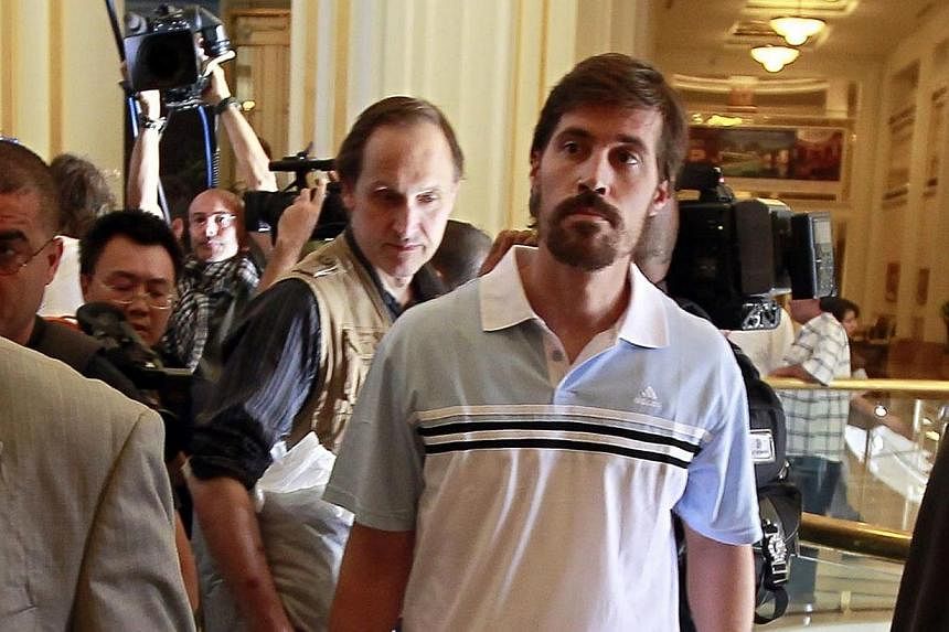US journalist James Foley (right) arrives with fellow reporter Clare Gillis (not pictured), after being released by the Libyan government, at Rixos hotel in Tripoli, in this picture taken on May 18, 2011.&nbsp;The United States Justice Department is 