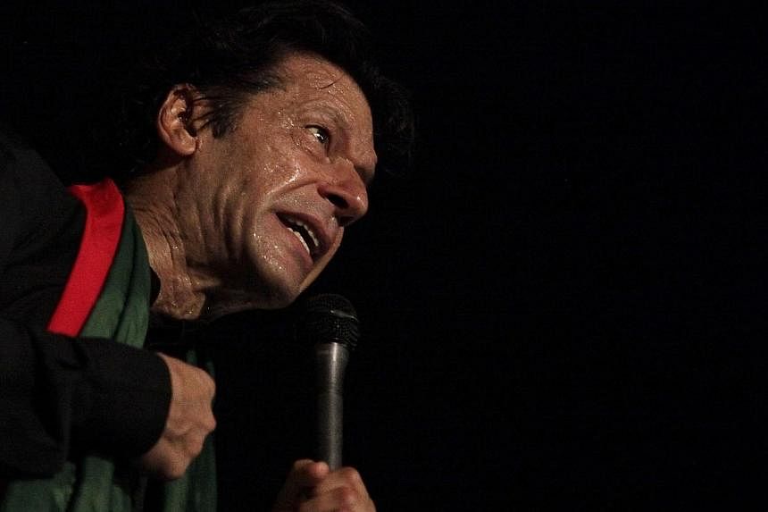 Pakistani opposition politician Imran Khan addresses his supporters during what has been dubbed a "freedom march" in Islamabad on Aug 20, 2014. -- PHOTO: REUTERS