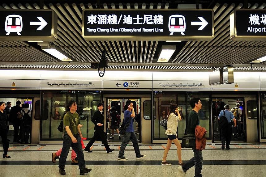 Commuters in a Mass Transit Railway (MTR) station in Hong Kong.&nbsp;&nbsp;Hong Kong's animal lovers heaped fury on the city's subway operator on Thursday, Aug 21, 2014, after rail workers failed to stop a dog from being run over by a train. -- PHOTO