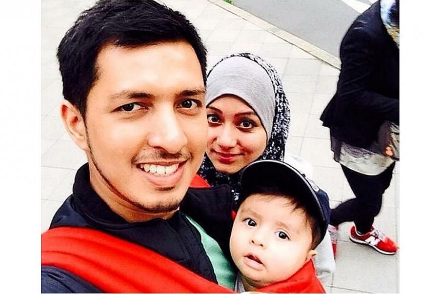 Doting dad lost: Ahmad Hakimi carrying eight-month-old Abderrahman while his wife Asmaa looks on. Ahmad Hakimi was very attached to Abderrahman and enjoyed taking care of him. -- PHOTO: THE STAR/ASIA NEWS NETWORK