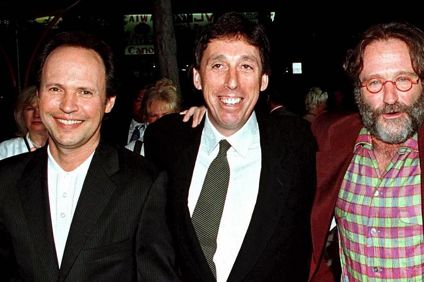 Hollywood director Ivan Reitman (centre) poses with Robin Williams (right) and Billy Crystal as they arrive for the premiere of their movie Father's Day at Mann's Chinese Theatre in Hollywood in this file picture taken May 6, 1997. Crystal and Willia