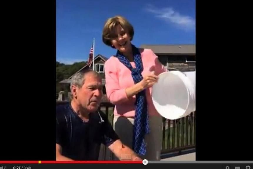 Former US president George W. Bush is doused in ice water by wife Laura as part of the so-called Ice Bucket Challenge in support of Lou Gehrig's disease research on Wednesday. He nominated former US president Bill Clinton to take the challenge. &nbsp