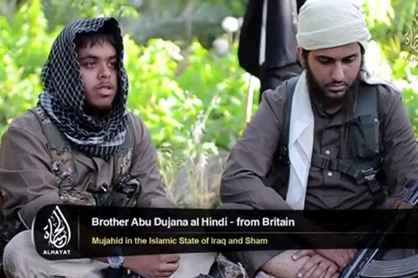 An Islamist fighter, identified as Abu Bara' al-Hindi from Britain (left), speaks in this still image taken from an undated video shot at an unknown location and uploaded to a social media website on June 19, 2014. He is among 400-500 British nationa