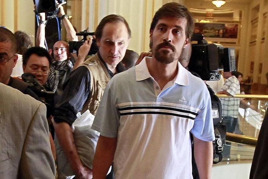 US journalist James Foley (right) arrives with fellow reporter after being released by the Libyan government, at Rixos hotel in Tripoli, in this picture taken on May 18, 2011. -- PHOTO: REUTERS