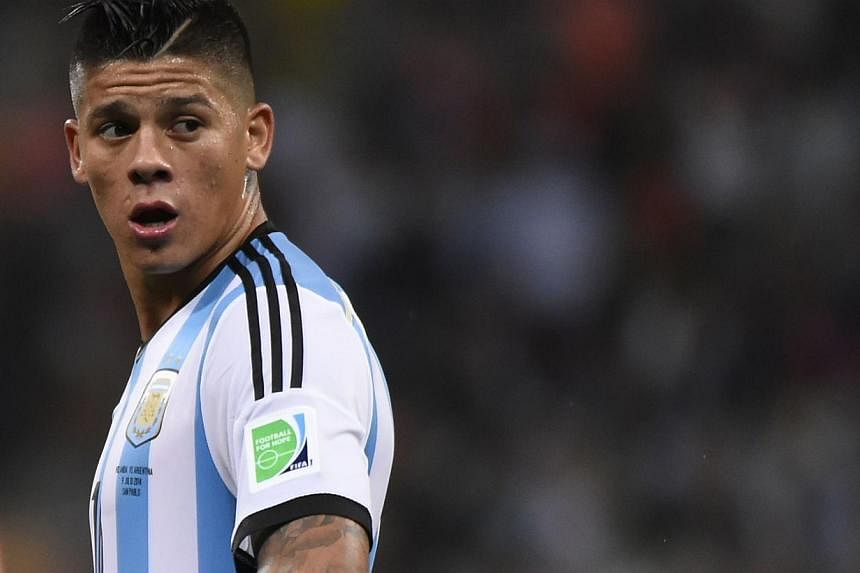 In this file picture taken on July 9, 2014, Argentina's defender Marcos Rojo reacts during the second half of extra time during the semi-final football match between Netherlands and Argentina at the FIFA World Cup in Sao Paulo. Manchester United on W