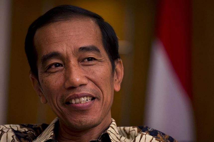 President-elect Joko Widodo will sit down with Indonesia's outgoing leader next week in the hope of reaching an agreement to raise fuel prices before the handover in October, a move that would help ease budget-sapping subsidy costs. -- PHOTO: AFP