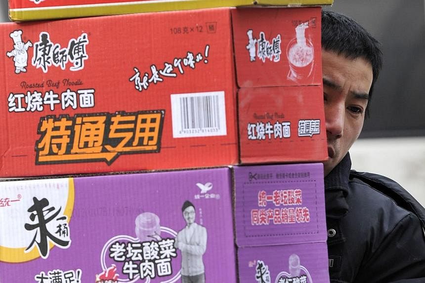 A man delivers boxes containing instant noodles. Women who eat instant noodles, like Ramen, at least two times a week face a greater risk of high blood pressure, elevated blood sugar and high cholesterol, US researchers said on Thursday. -- PHOTO: AF