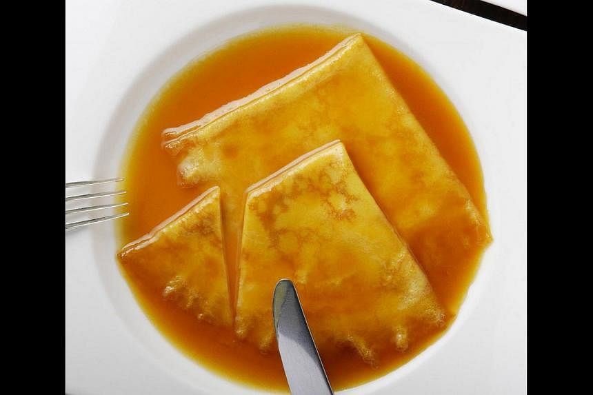Diners can tuck into the thin sweet crepes of Henri Charpentier’s signature dish Crepe Suzette (above), when the patiserrie opens at Dempsey Hill. -- PHOTO: HENRI CHARPENTIER