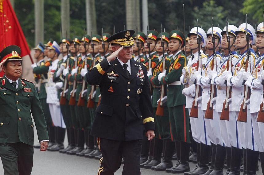General Martin Dempsey and his Vietnamese counterpart, Senior Lieutenant-General Do Ba Ty, reviewing the guard of honour during a welcoming ceremony held at the Defence Ministry in Hanoi on Aug 14. Gen Dempsey's visit to Vietnam earlier this month - 