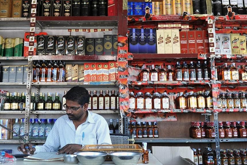 An Indian employee writing down stock at an alcohol store in Hyderabad, India on Feb 28, 2013. The authorities in Kerala announced a ban on alcohol on August 22, 2014 to tackle a growing abuse problem in the southern Indian state, a popular tourist d