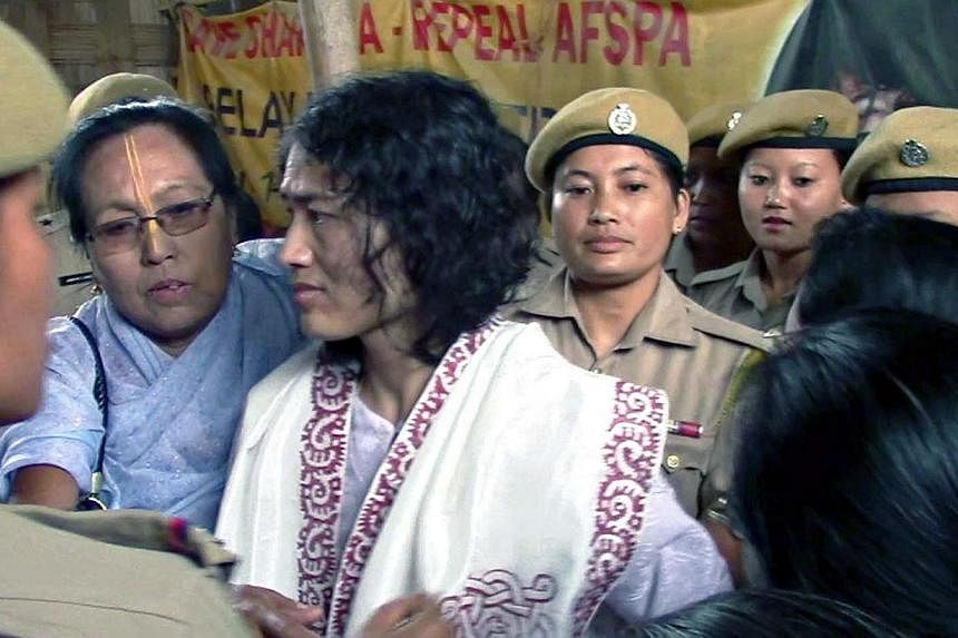 Indian rights activist Irom Sharmila, who has been on hunger strike for fourteen years, being led by policewomen after her rearrest at the site of her protest in Imphal, capital of India's north-eastern Manipur state, on August 22, 2014. Indian polic