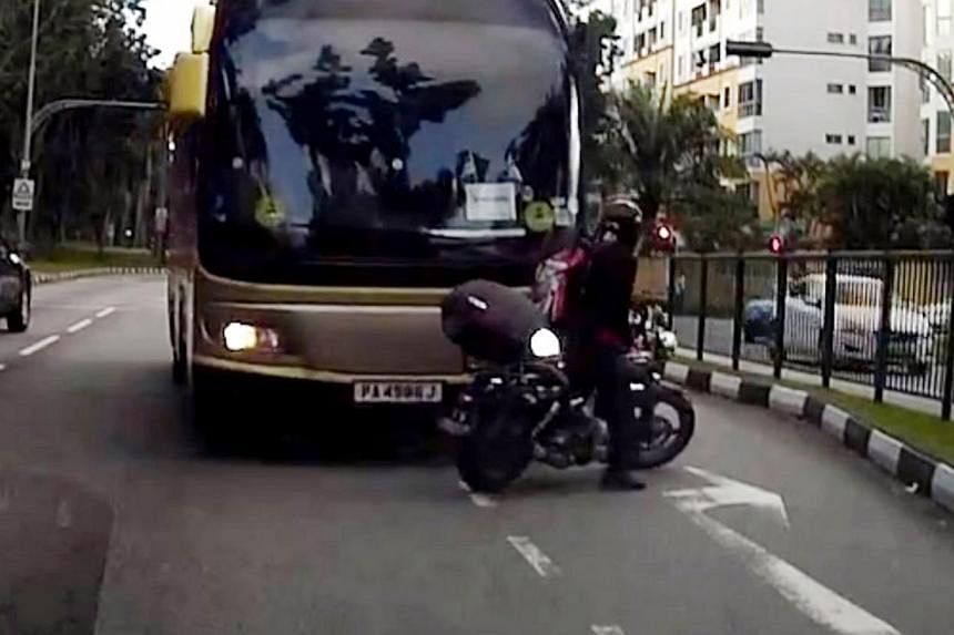A screengrab from a video clip showing a bus, which was going against the flow of traffic, crashing into a motorcycle. -- PHOTO: SINGAPORE RECKLESS DRIVERS/YOUTUBE