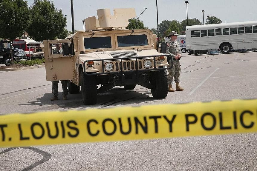 Military police with the Missouri Army National Guard stand guard at the police command center which was established to direct security operations following unrest after the recent death of Michael Brown on Aug 21, 2014 in Ferguson, Missouri.&nbsp;--