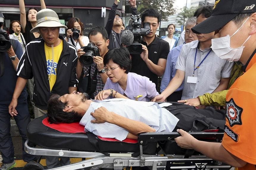 Kim Young Oh, 47, who lost his 16-year-old daughter in the Sewol ferry disaster, is wheeled to an ambulance on a stretcher after 40 days of fasting in Seoul on Aug 22, 2014. -- PHOTO: REUTERS