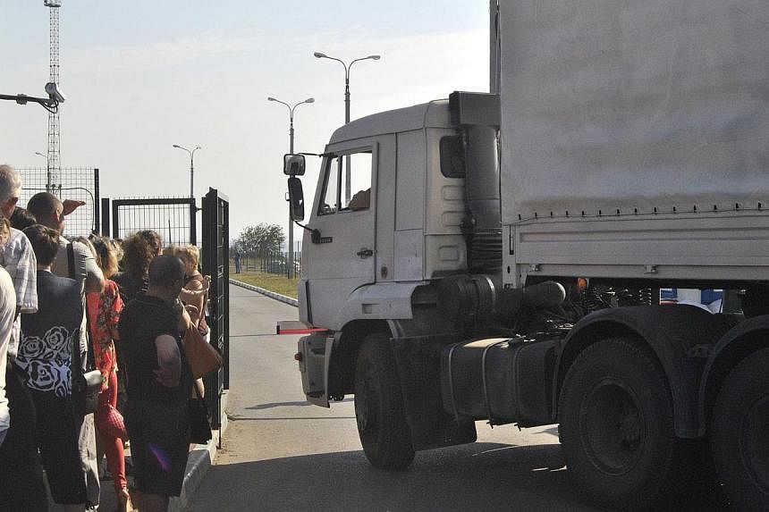 A lorry, part of a Russian humanitarian aid convoy, waits to cross the border at the Donetsk-Izvarino border checkpoint, near the town of Donetsk in the Rostov region, on Aug 23, 2014. -- PHOTO: AFP