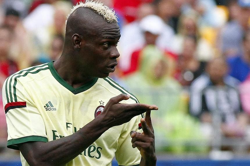 Mario Balotelli #45 of AC Milan signals to teammates against Manchester City during International Champions Cup 2014 at Heinz Field in Pittsburgh, Pennsylvania on July 27, 2014. -- PHOTO: AFP