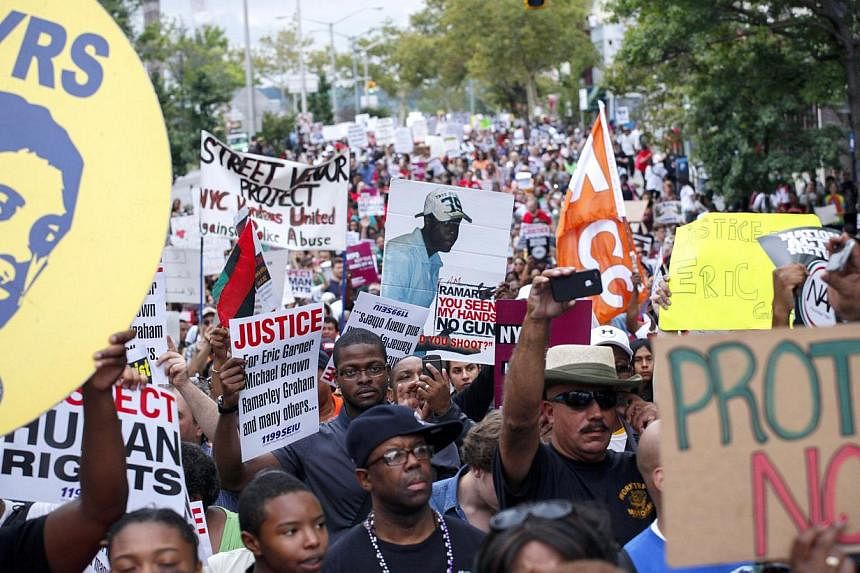 People march during rally against police violence on Aug 23, 2014 in the borough of Staten Island in New York City. -- PHOTO: AFP