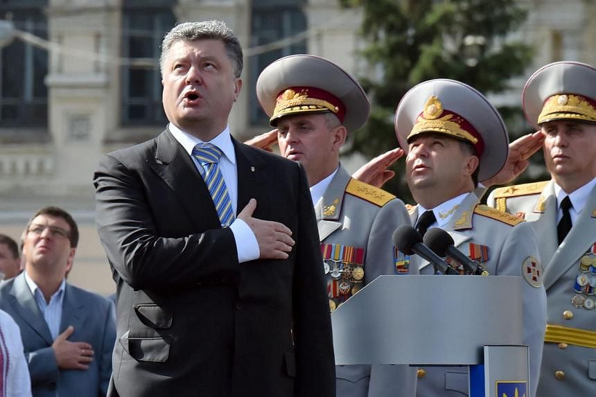Ukrainian President Petro Poroshenko and the supreme command staff sing the national anthem during a military parade marking the 23rd anniversary of Ukraine's independence in the center of Kiev on Aug 24, 2014.&nbsp;Ukraine's President Petro Poroshen