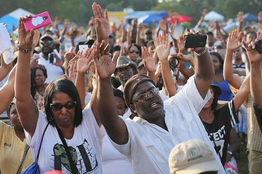 People attend the Peace Fest music festival in Forest Park on Aug 24, 2014 in St. Louis, Missouri.&nbsp;Thousands are expected on Monday, Aug 25, to attend the funeral of the unarmed black teen shot dead by a white policeman in Missouri, two weeks af