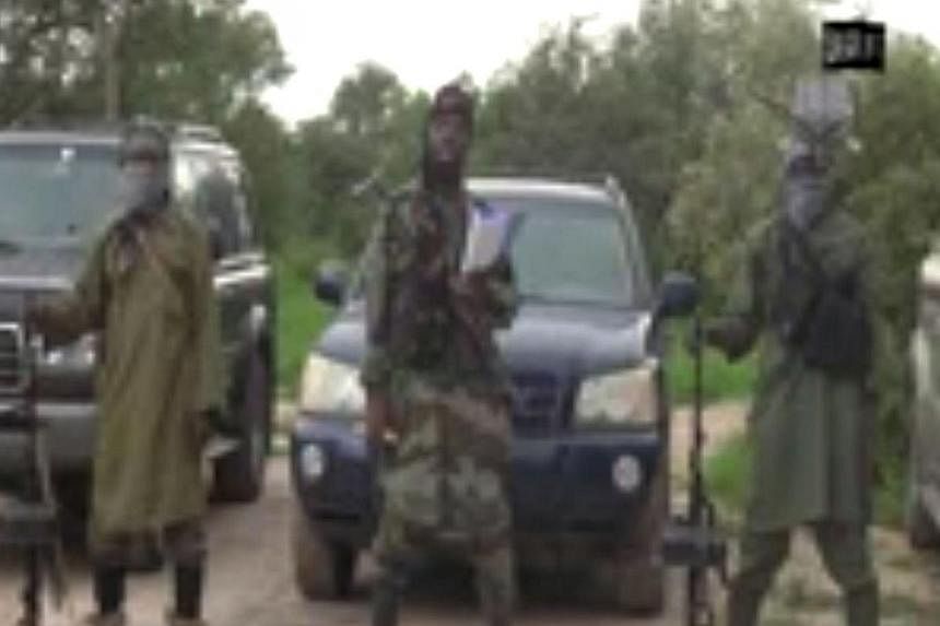 A screengrab taken on August 24, 2014 from a video released by the Nigerian Islamist extremist group Boko Haram and obtained by AFP shows the leader of the Nigerian Islamist extremist group Boko Haram, Abubakar Shekau (centre), delivering a speech at