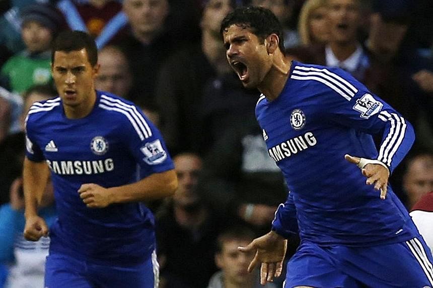 Chelsea's Diego Costa (right) celebrates his goal against Burnley during their English Premier League soccer match at Turf Moor in Burnley, northern England August 18, 2014. -- PHOTO: REUTERS