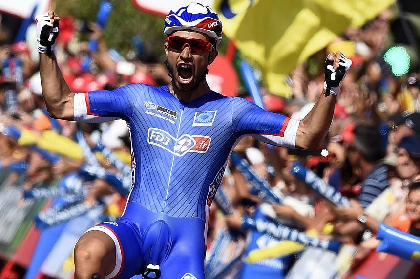 French cyclist Nacer Bouhanni celebrates as he crosses the finish line to win the second stage of the 69th edition of La Vuelta Tour of Spain, a 174.4km ride from Algeciras to San Fernando, on August 24, 2013. -- PHOTO: AFP&nbsp;