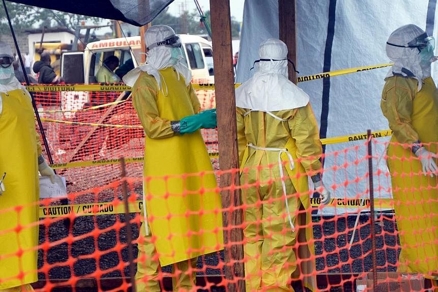 French NGO Medecins Sans Frontieres (MSF - Doctors Without Borders) staff members standing wearing protective gear at the MSF ELWA hospital in Monrovia, where patients suffering from Ebola are taken care of. A Liberian doctor treated with experimenta