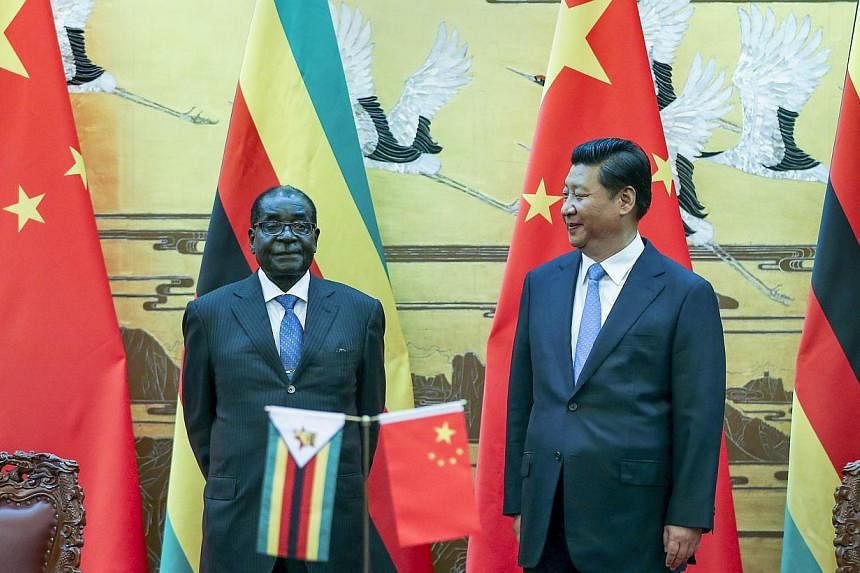 Zimbabwean President Robert Mugabe (left) and his Chinese counterpart Xi Jinping pose during a signing ceremony at the Great Hall of the People in Beijing on August 25, 2014. China's President Xi hailed Mugabe - a pariah in the West - as a renowned A