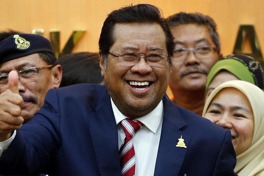 Selangor Chief Minister Khalid Ibrahim (centre) smiles following a news conference at Selangor state government headquarters in Shah Alam outside Kuala Lumpur on Aug 11, 2014.&nbsp;Tan Sri Khalid was in a meeting with the Selangor sultan on Tuesday a