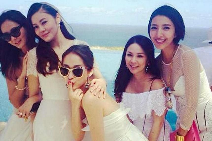 Fan Chiang (in veil) posing with her Taiwanese friends at Monday's wedding. -- PHOTO: KENNY BEE