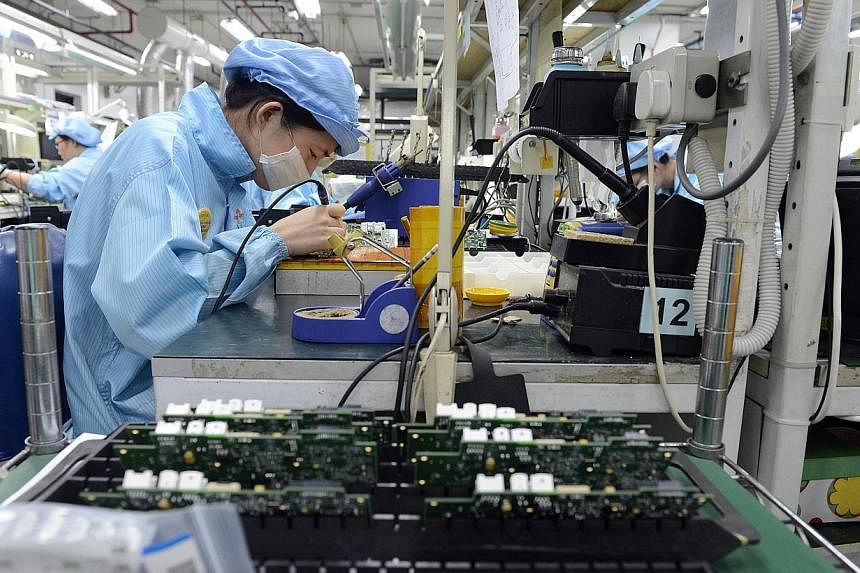 Workers at Add-Plus, an electronics manufacturing company that makes printed circuit boards.&nbsp;Manufacturers in Singapore produced 3.3 per cent more output in July than a year ago, investment promotion agency EDB said on Tuesday, Aug 26, 2014. -- 