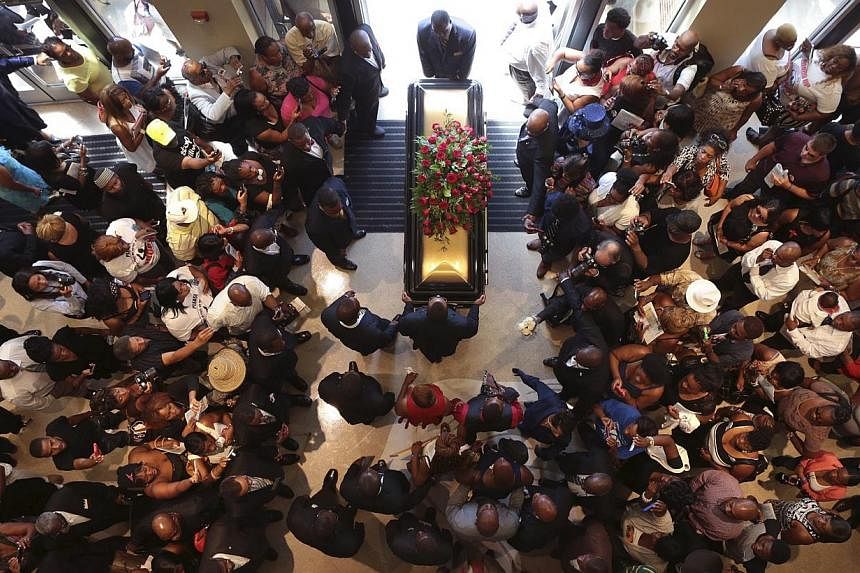 Family and supporters of Michael Brown celebrated the life of the black teenager killed by a white police officer in Ferguson, Missouri, in a music-filled funeral service ringing with calls for peace and police reforms. -- PHOTO: REUTERS